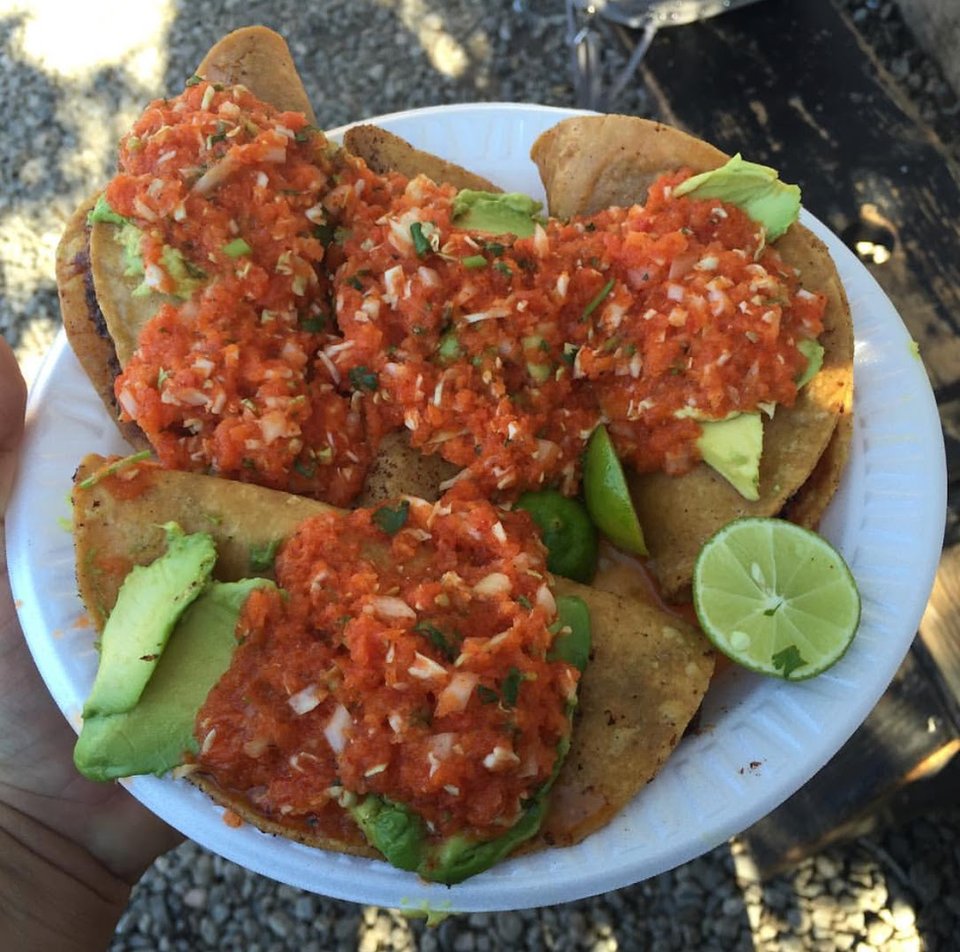 Shrimp tacos served with fresh garnishes.